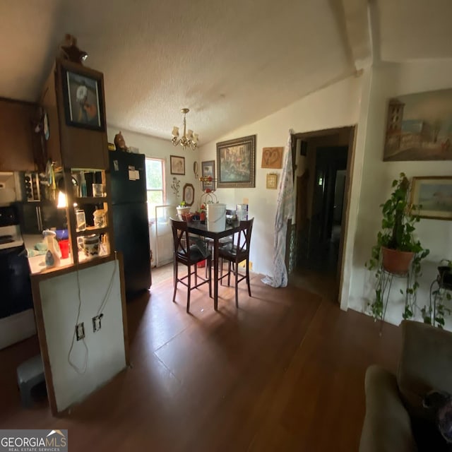 dining room featuring wood-type flooring, lofted ceiling, and a notable chandelier