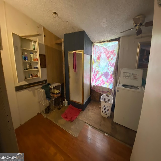 kitchen with wood-type flooring, washer / dryer, ceiling fan, and a textured ceiling