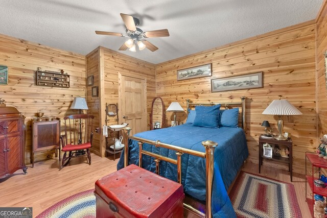 bedroom featuring a textured ceiling and wood finished floors