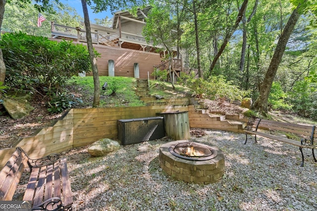 view of yard with stairway and an outdoor fire pit