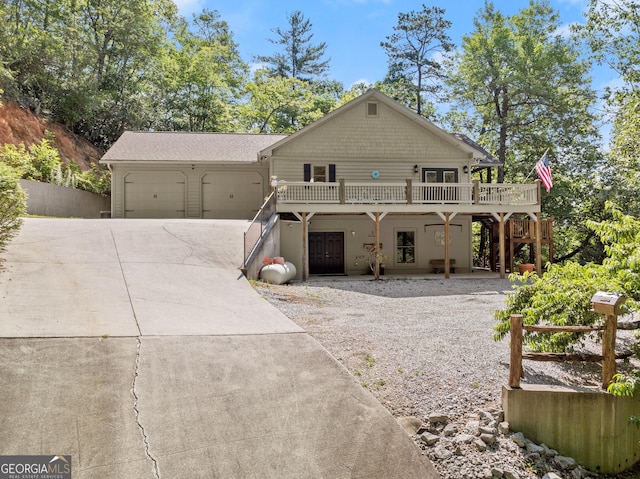 rustic home with stairway, driveway, a wooden deck, and a garage