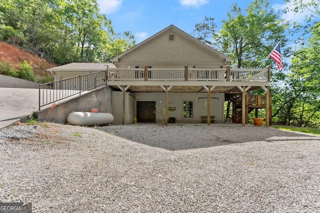 rear view of house featuring a wooden deck