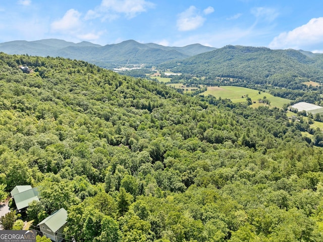 exterior space with a view of trees and a mountain view