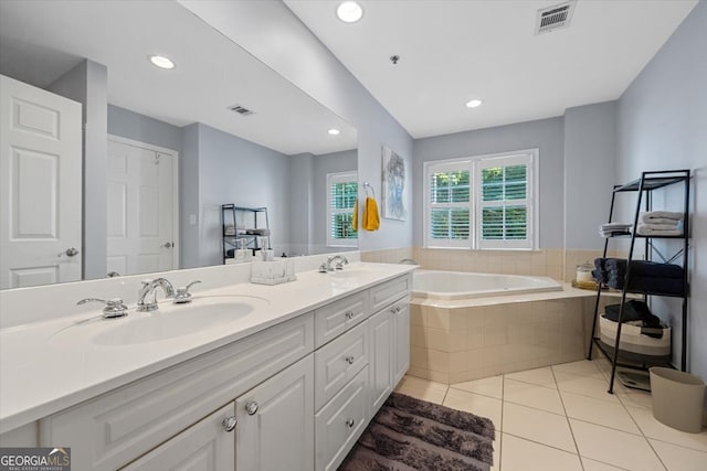 bathroom with vanity, tile patterned floors, and a relaxing tiled tub