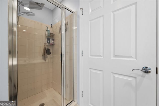 bathroom featuring a shower with door