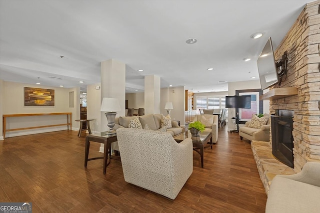 living room with a fireplace and dark hardwood / wood-style flooring