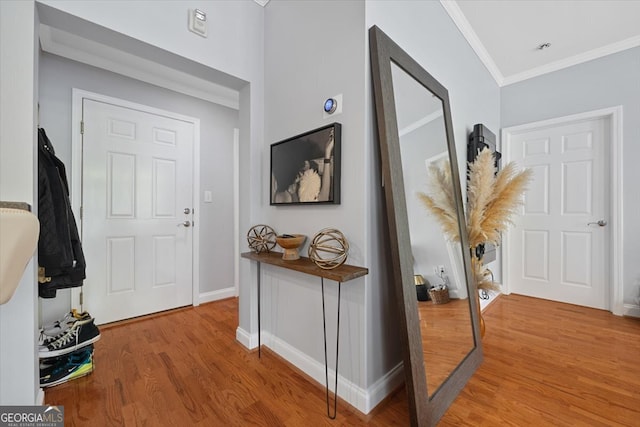 hallway featuring ornamental molding and hardwood / wood-style flooring