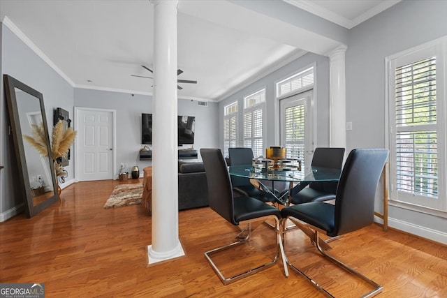 dining space featuring hardwood / wood-style flooring, plenty of natural light, and ornate columns