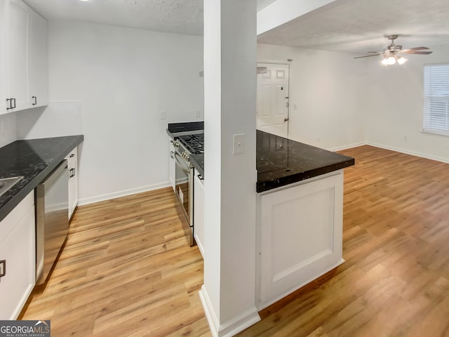 kitchen featuring ceiling fan, white cabinets, appliances with stainless steel finishes, and light wood-type flooring