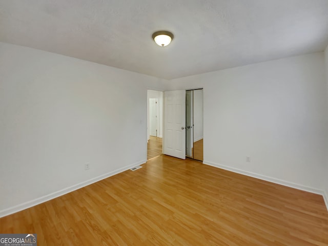 unfurnished room featuring light wood-type flooring