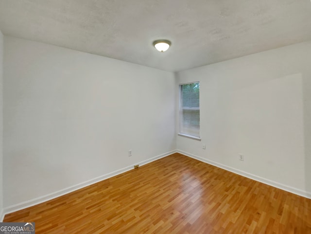 unfurnished room featuring hardwood / wood-style floors