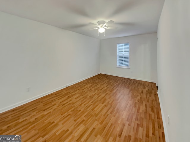 empty room with light wood-type flooring and ceiling fan