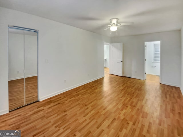 unfurnished bedroom with ceiling fan and light wood-type flooring