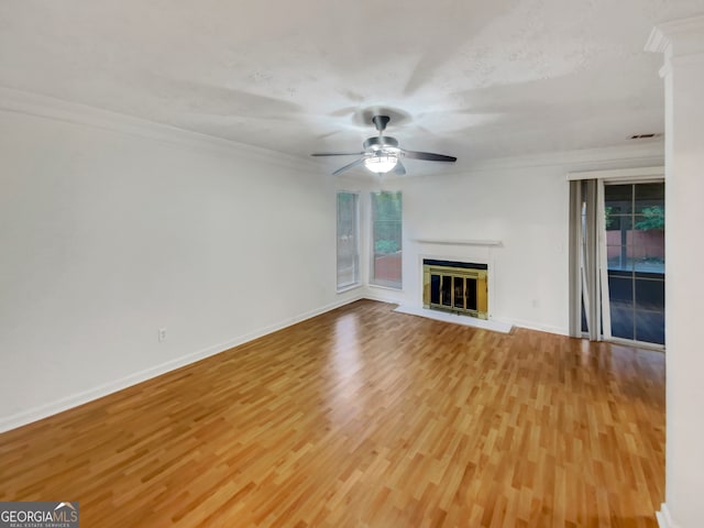 unfurnished living room with ornamental molding, ceiling fan, and light hardwood / wood-style flooring