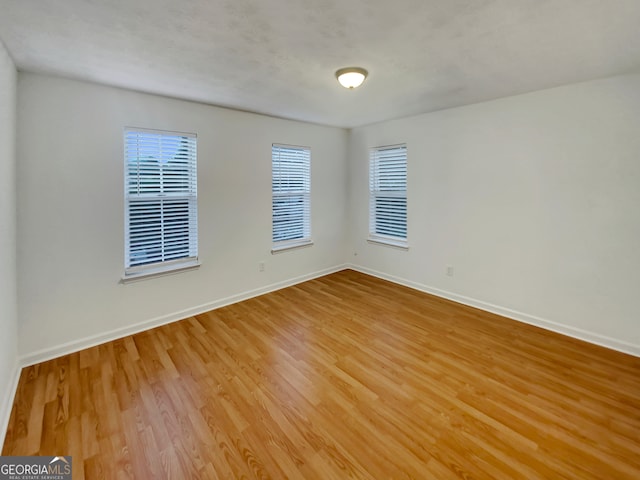 spare room with light hardwood / wood-style flooring