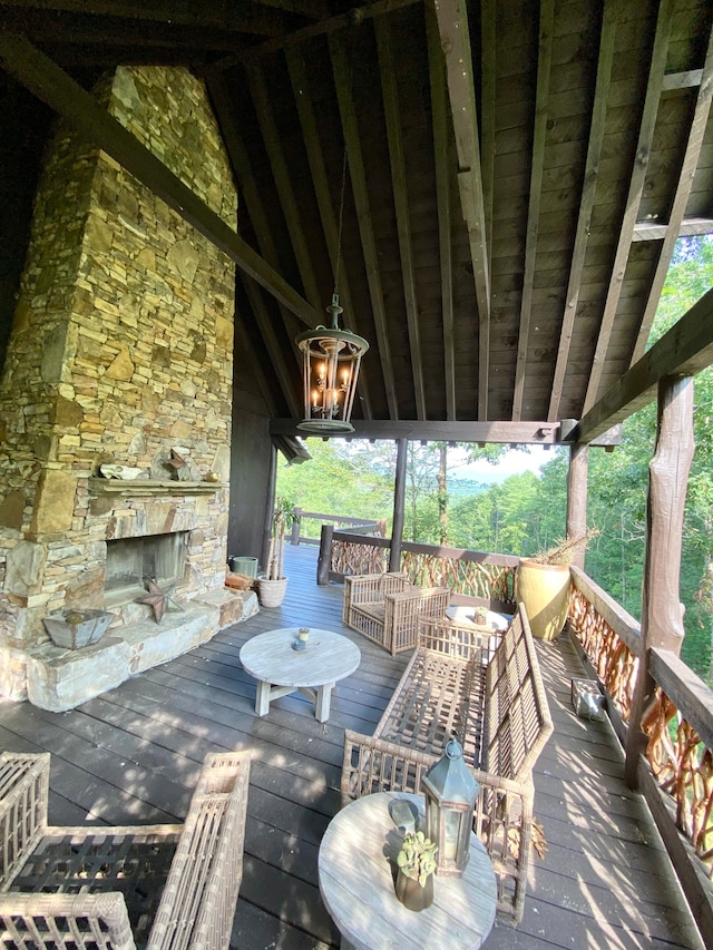 deck featuring an outdoor stone fireplace