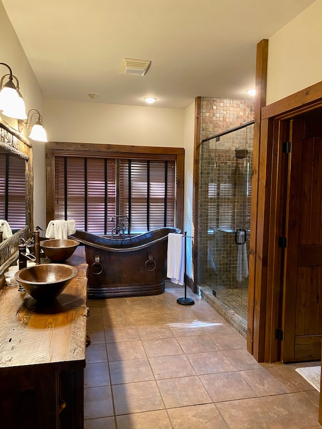 bathroom with vanity, a shower with door, and tile patterned floors