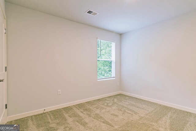 spare room with light colored carpet