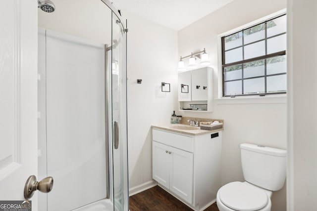 bathroom featuring an enclosed shower, hardwood / wood-style floors, vanity, and toilet