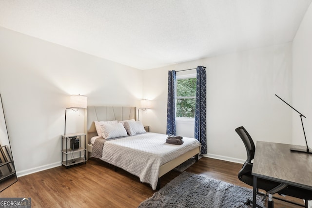 bedroom with dark wood-type flooring