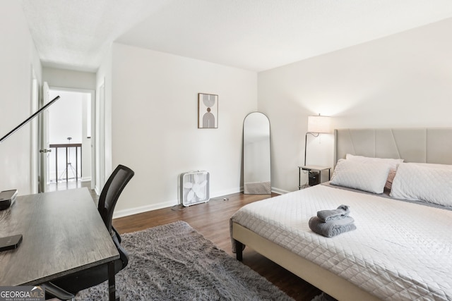 bedroom featuring dark hardwood / wood-style flooring