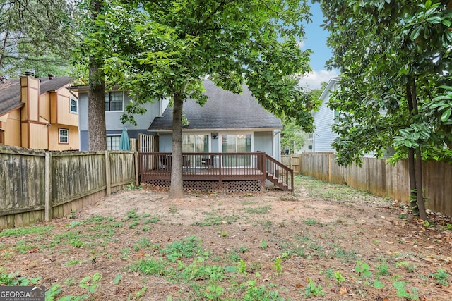 rear view of house with a wooden deck