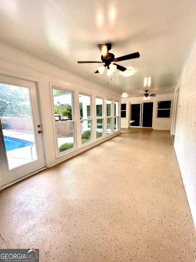 unfurnished living room featuring ceiling fan