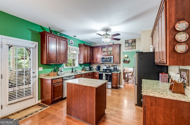 kitchen featuring ceiling fan, appliances with stainless steel finishes, light wood-type flooring, and a wealth of natural light