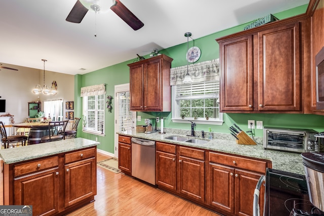 kitchen with ceiling fan with notable chandelier, dishwasher, pendant lighting, light hardwood / wood-style flooring, and sink