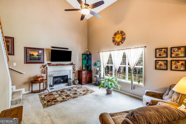 carpeted living room featuring a fireplace, ceiling fan, and high vaulted ceiling