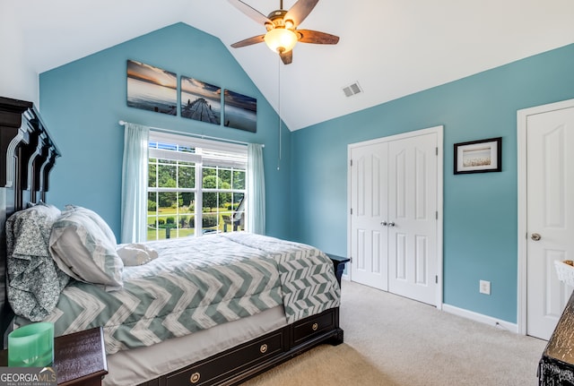 carpeted bedroom with lofted ceiling, ceiling fan, and a closet