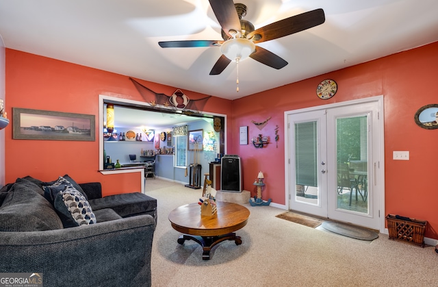 living room featuring ceiling fan, light colored carpet, and french doors