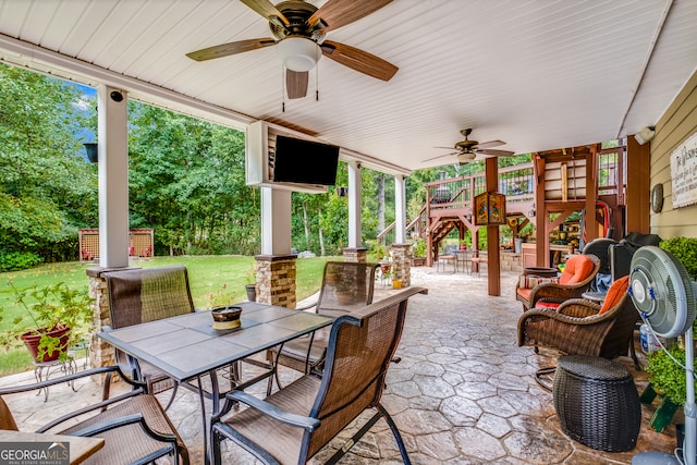 view of patio with a playground, ceiling fan, and a shed