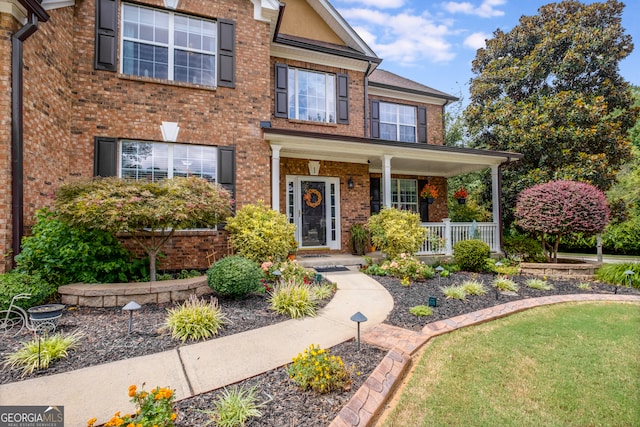 view of front of property with a front yard and covered porch