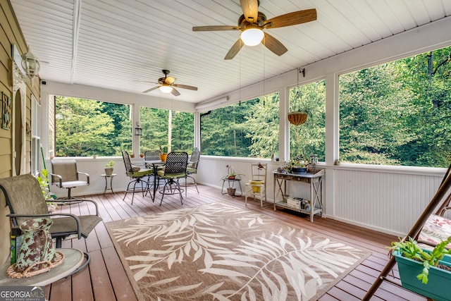 sunroom featuring ceiling fan and outdoor dining space