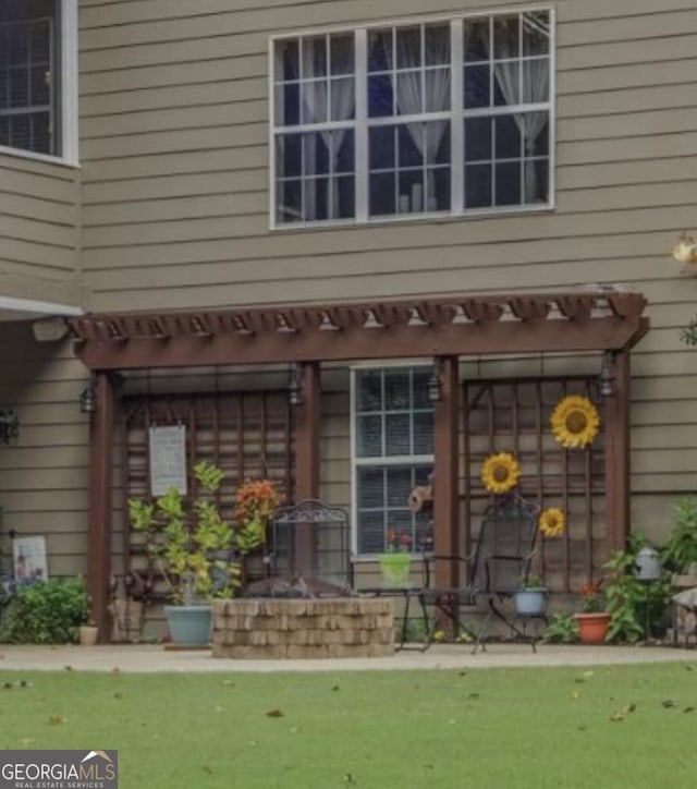 entrance to property with a pergola
