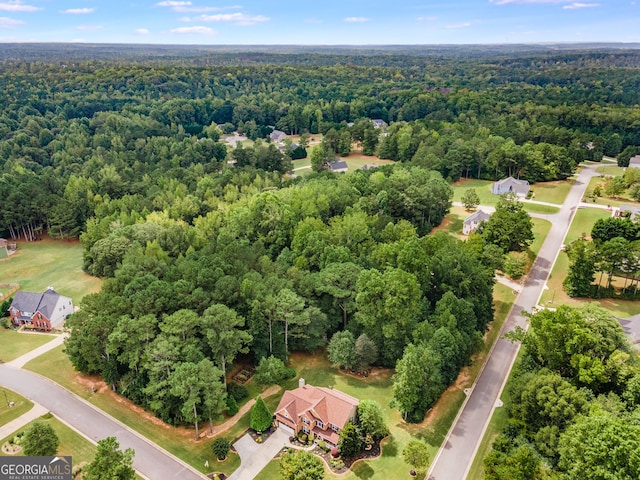 birds eye view of property with a forest view