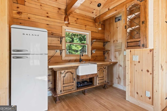 kitchen with wood ceiling, pendant lighting, white fridge, beam ceiling, and light hardwood / wood-style flooring