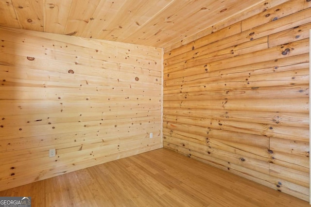 empty room featuring wood ceiling and hardwood / wood-style flooring