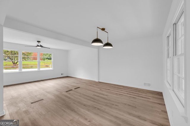 empty room featuring ceiling fan and light hardwood / wood-style flooring