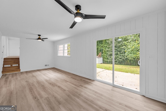 unfurnished living room featuring light hardwood / wood-style floors and ceiling fan