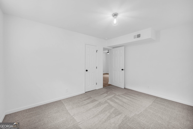 empty room featuring light carpet