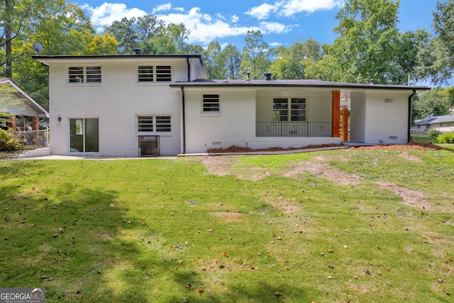 rear view of property with a lawn, a patio, and central air condition unit