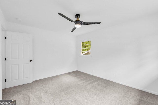 carpeted spare room with ceiling fan