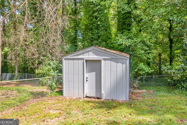 view of outbuilding with a yard