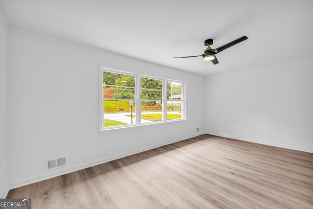 unfurnished room with ceiling fan and light wood-type flooring