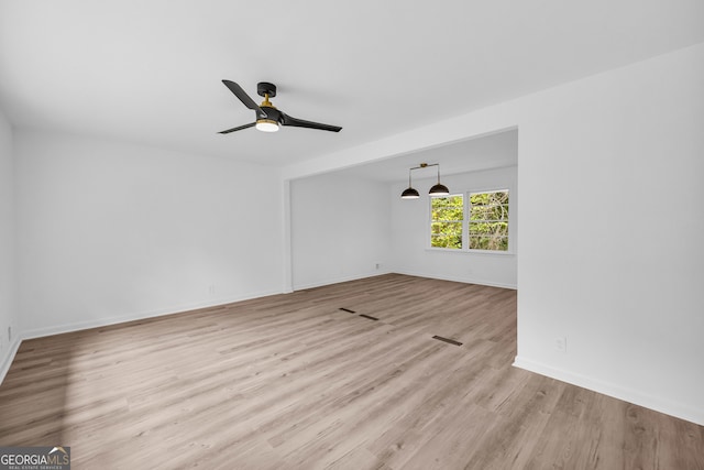 unfurnished room featuring light wood-type flooring and ceiling fan