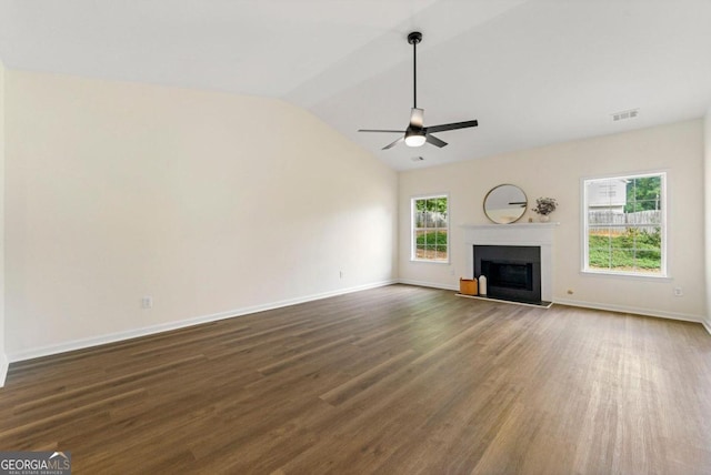 unfurnished living room featuring ceiling fan, dark hardwood / wood-style flooring, and vaulted ceiling