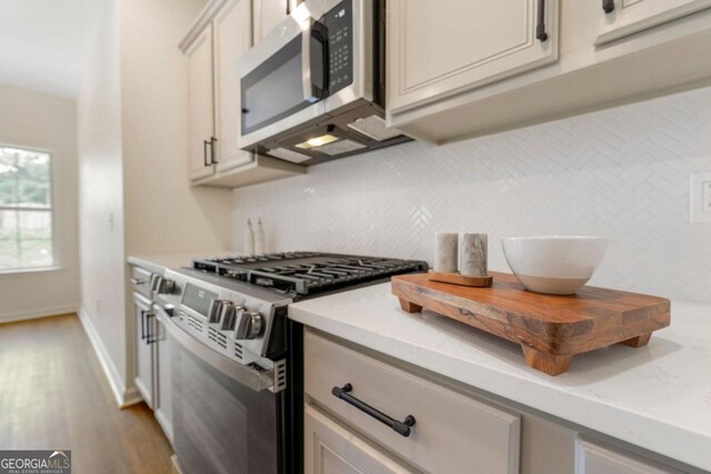 kitchen featuring light hardwood / wood-style floors and appliances with stainless steel finishes