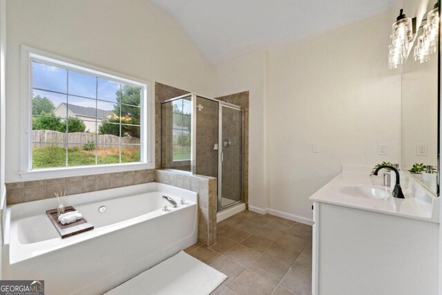 bathroom with tile patterned floors, vanity, separate shower and tub, and lofted ceiling